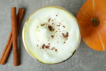 Concept of pumpkin latte on gray textured table
