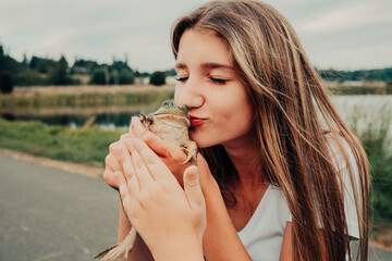 girl kissing a frog 