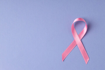 Breast cancer awareness ribbon on violet background