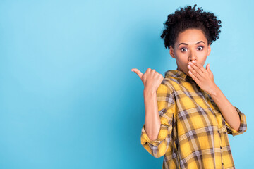 Photo portrait curly woman wearing checkered shirt showing thumb copyspace amazed isolated pastel...