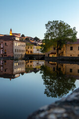 Old buildings in Viseu city reflected in the river Pavia at night , Portugal - obrazy, fototapety, plakaty