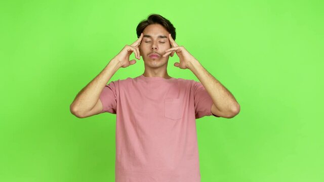 Young man unhappy and frustrated with something over isolated background. Green screen chroma key