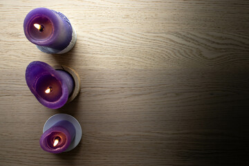 three purple candles with space next to the for logos and more stuff