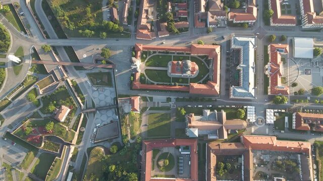 Top down aerial of ancient historic site in Alba Iulia, Romania. Rooftops of the St. Michael's Cathedral and the Reunification Cathedral are visible