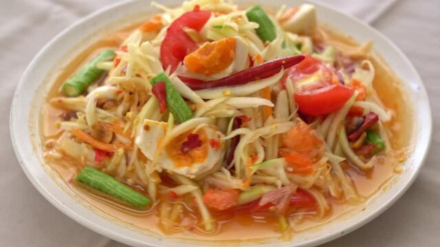 Som Tum - Thai Spicy green papaya salad with salty eggs - Asian food style