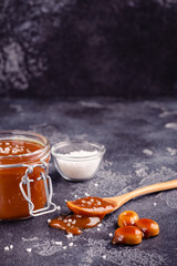 Glass jar with tasty delicious salted caramel