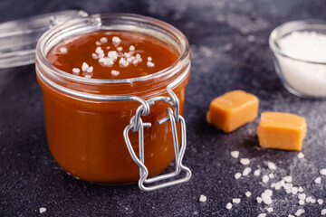 Glass jar with tasty delicious salted caramel