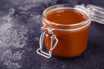 Glass jar with tasty delicious salted caramel