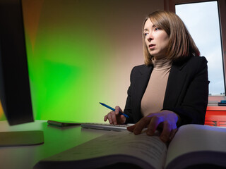 Accounting outsourcing. A female financier works remotely. A woman works with documents at the...