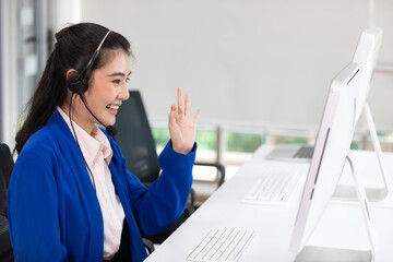 woman operator wearing headphones, talking online with customer and okay sign pose at call center...