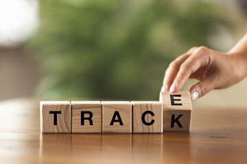 Female hand turning wooden cubes, blocks and change sense of word. Conceptual image about human rights, education, social issues, mental health, education and personal development.