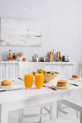 Fototapeta na wymiar fresh fruits, delicious pancakes and orange juice on table served for breakfast