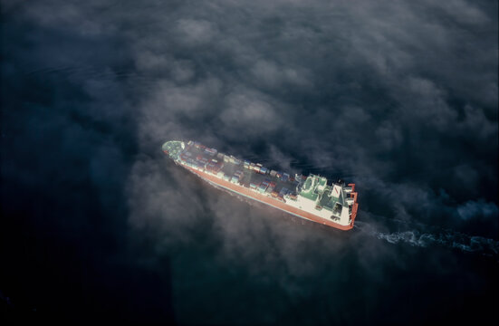 Aerial of Scans Carrrier loaded with cargo sailing through fog