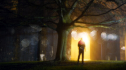 A mysterious figure standing by street lights on a misty winters night. With a blurred, bokeh, out of focus edit