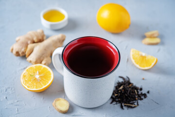 Obraz na płótnie Canvas Cup of black tea with honey, lemon and ginger