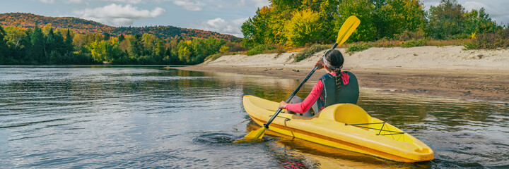 Kayak on river in Laurentians, Quebec .Canada travel destination banner. Woman kayaker kayaking...