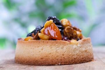 dough tartlet nuts and dried fruits covered with caramel