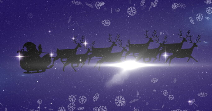 Image of black silhouette of santa claus in sleigh being pulled by reindeer and winter christmas