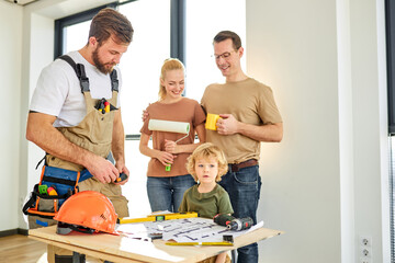 construction worker assistant with family in new apartment. Builder and customers clients, discuss Repair plan. Childrens creativity. Repairman in uniform. Kid boy is interested in building tools