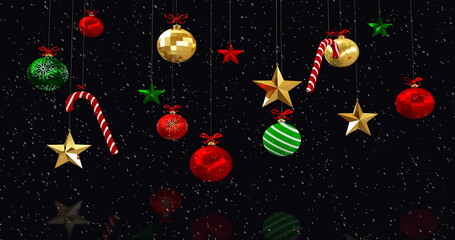 Image of christmas decorations and baubles with snow falling