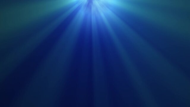 Rays of blue lights from the sky on the blue background. 4K motion footage.