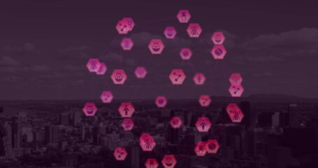 Globe of digital icons against cityscape