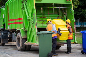 Garbage collection service,Rubbish cleaner man in a uniform working together on emptying dustbins...