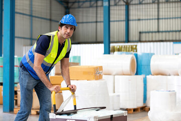 factory worker with boxes package and pushing trolley in the warehouse storage