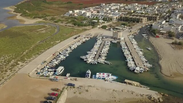 Aerial circling over touristic port of Torre Pali in Puglia, Italy