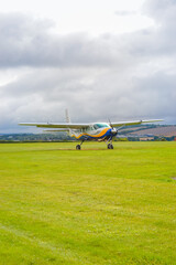 Fototapeta na wymiar UK, Salisbury, 15.08.2021: a small plane from 'GoSkydive' awaits people to land for parachute jumping
