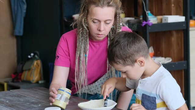 workshop for kids. Children learning how to use clay for making beautiful dishes. Workshop, master class.