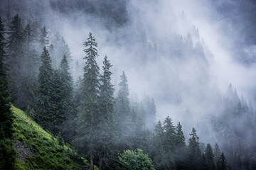 A rainy day in the Austrian Alps with deep clouds and fog - travel photography