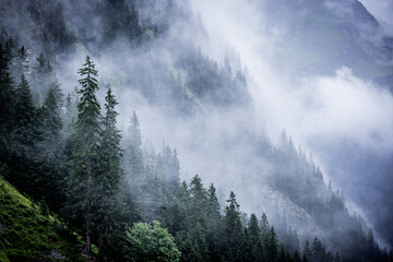 A rainy day in the Austrian Alps with deep clouds and fog - travel photography