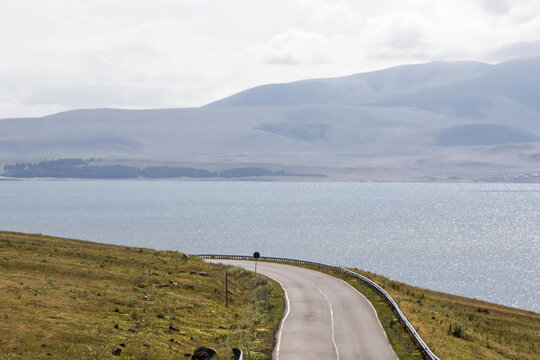 View of Paravani lake, a roadway, and mountains on the back, in Javakheti, Georgia