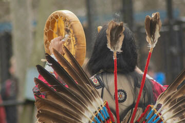 Tribal dance while beating a drum