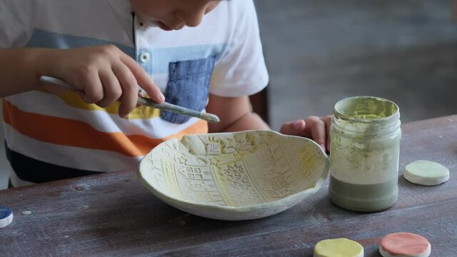 workshop for kids. Children learning how to use clay for making beautiful dishes. Workshop, master class.
