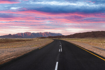 Asphalt road and beautiful landscape with sunset sky