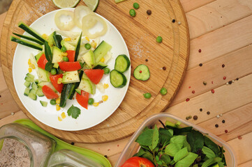 Homemade summer salad with tomato and cucumber, cooking at home