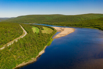 Aerial view of river Karasjohka, sandy beach and forest at the border of Finland and Norway