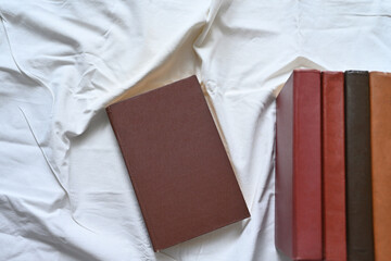 Antique books without inscriptions on a white background. Arrangement of objects. Book composition for design. Flat lay.