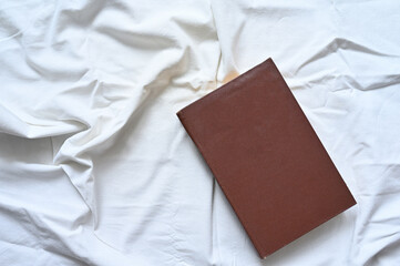 Closed book on a white background. An old book with a place for the inscription. Flat lay.