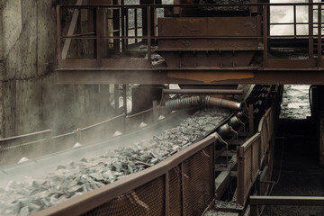 Conveyor belt transports hot briquetted iron. Metallurgical plant area. Speedy moving process.
