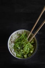 Foto op Canvas Asian food. Rice and Chuka salad in a white bowl.Top view. © Anastasiya Reiter