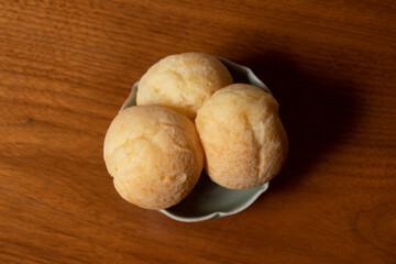 cheese rolls served in white dish on wooden table background, close-up photo and wooden background.