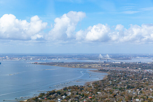 Mt. Pleasant, SC landscape. Arthur Ravenel Jr. Bridge in background. Docks extending into the ocean and beautiful clouds in the sky.