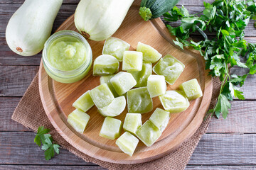 Frozen zucchini puree cubes on a cutting board on a table. Baby food. Frozen Food Concept.