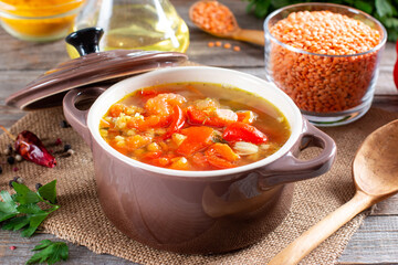 Red soup with lentils and vegetables on a table. Healthy food, healthy food.
