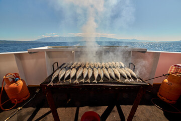 Fish barbecue during ship cruise on adriatic sea in Croatia