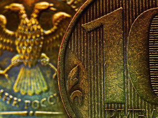 A fragment of a Russian coin in 10 ten rubles close up. Dark impressive illustration. Economy, finance and banks of Russia. Scratched coins from circulation. Macro