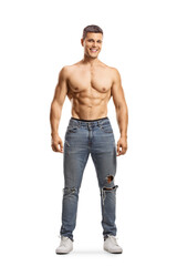 Fototapeta premium Full length profile shot of a shirtless muscular guy wearing jeans and looking at camera